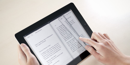 A woman reads Shakespeares Hamlet on a tablet