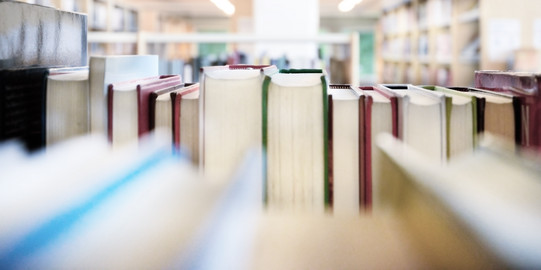 Books on shelf from behind Public library bookshelf with books from behind