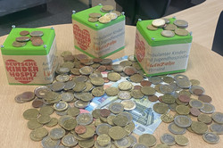 3 green donation boxes, cash and bills