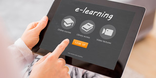 Hands with tablet for e-learning A woman's hands hold a tablet that says "e-learning" on it
