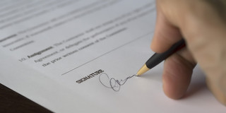 Contract is signed with a black pen