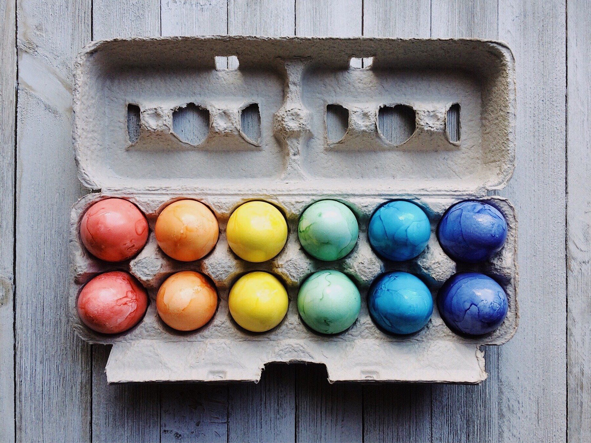 An egg carton with colorful Easter eggs