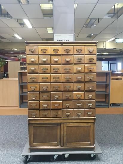 Wood cabinet with 48 small drawers and a large locker compartment