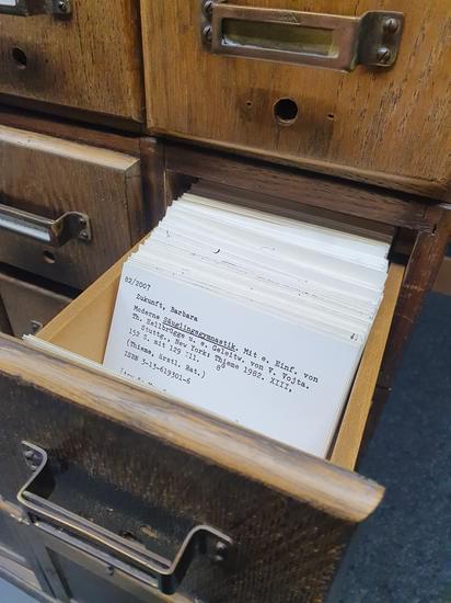 Wood cabinet: open drawer with catalog cards